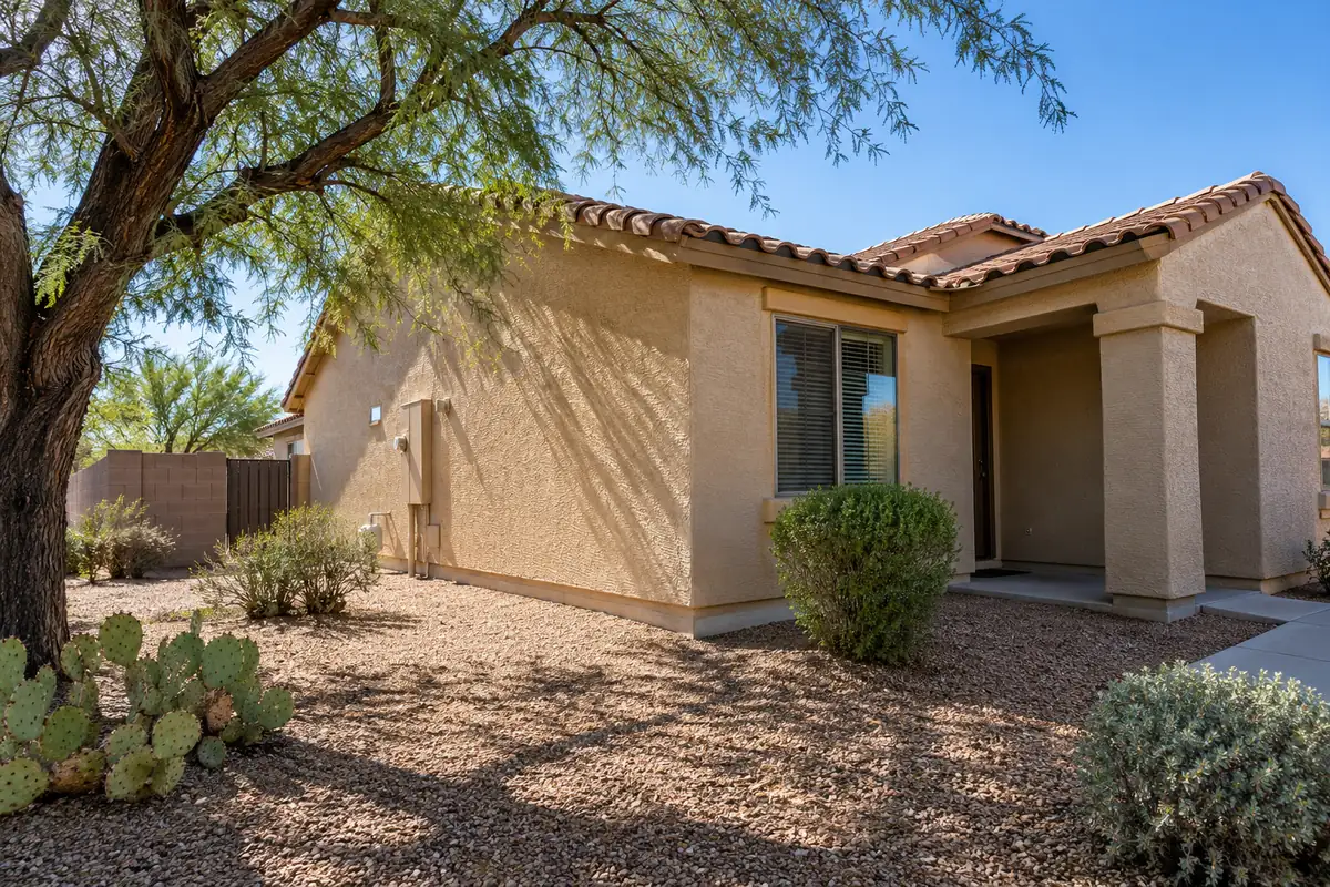 Stucco house with desert landscaping and a shade tree, cockroach control in Menifee, CA